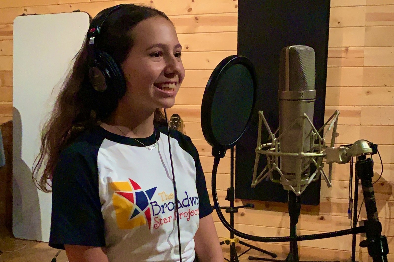 Young performers recording vocals in a professional studio